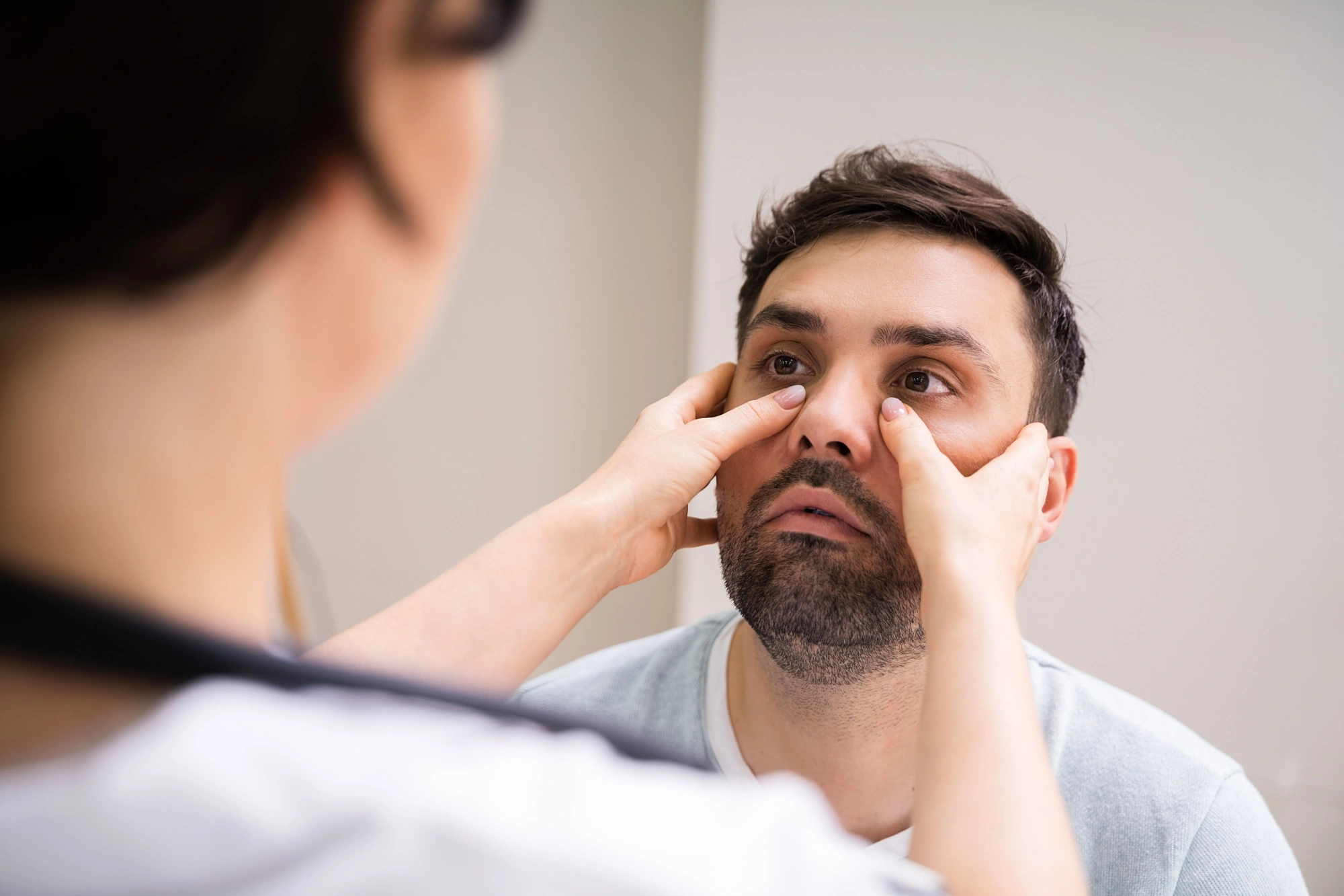 Doctor doing a sinus exam on a male patient