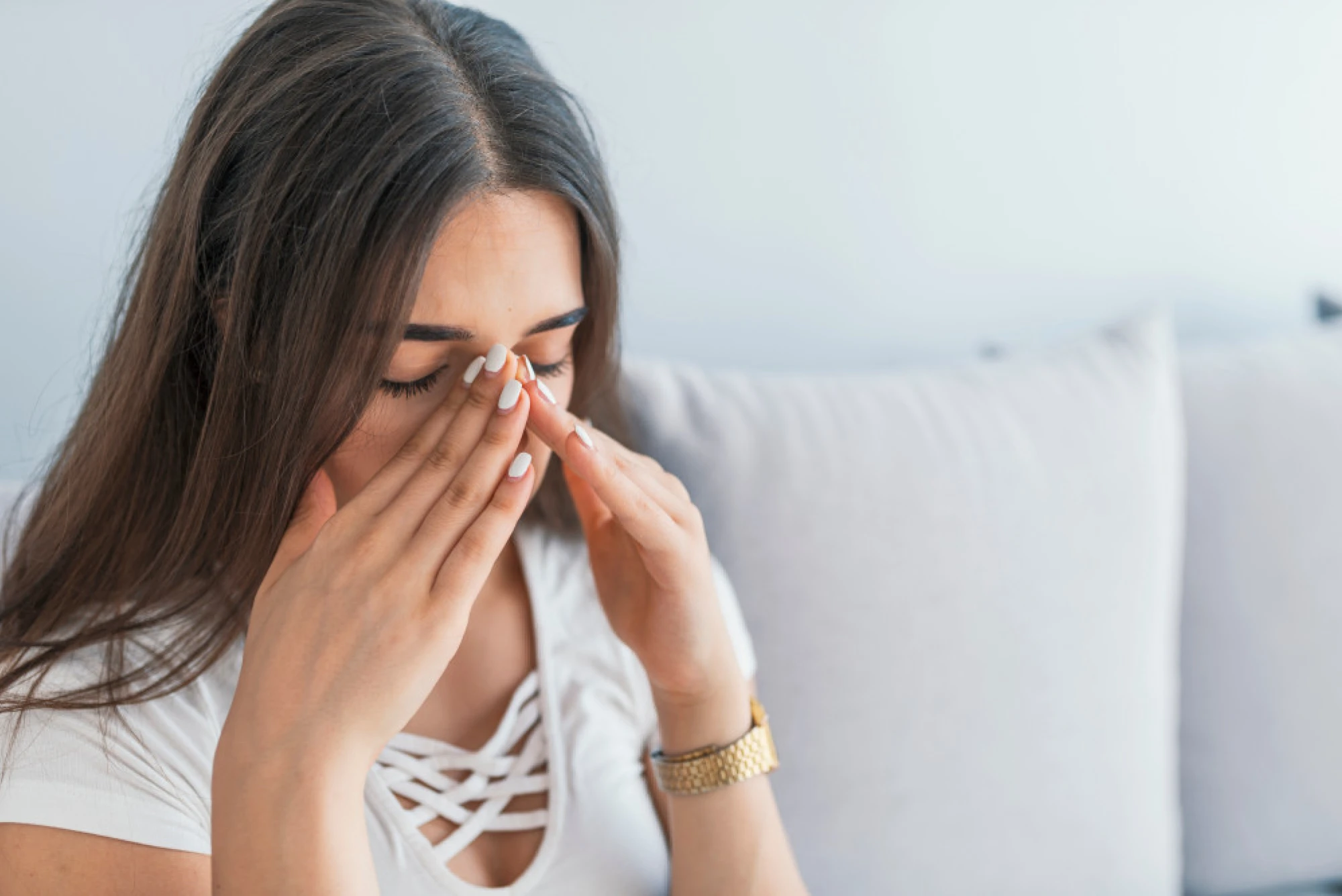 Woman pushing her fingers on her swollen sinuses
