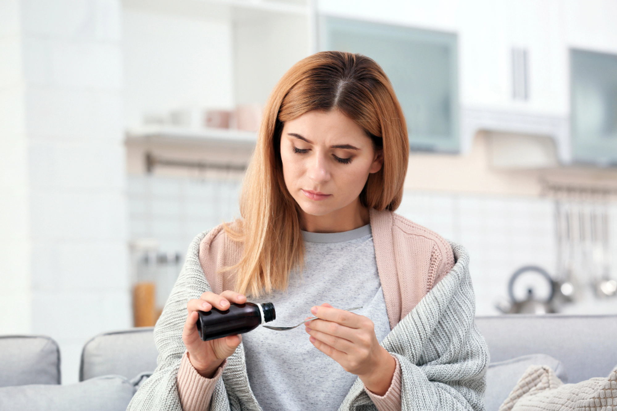 Woman taking medicine for a sinus infection