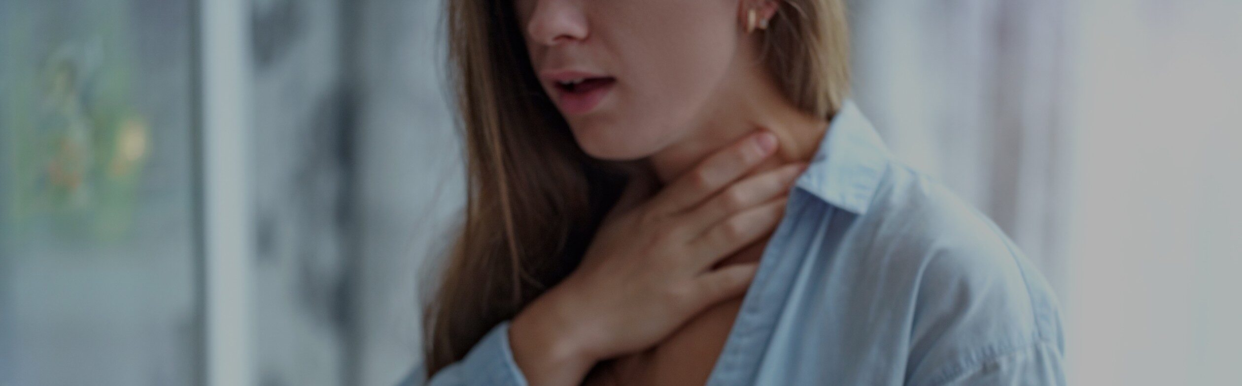 Woman with a peanut allergy holding her neck