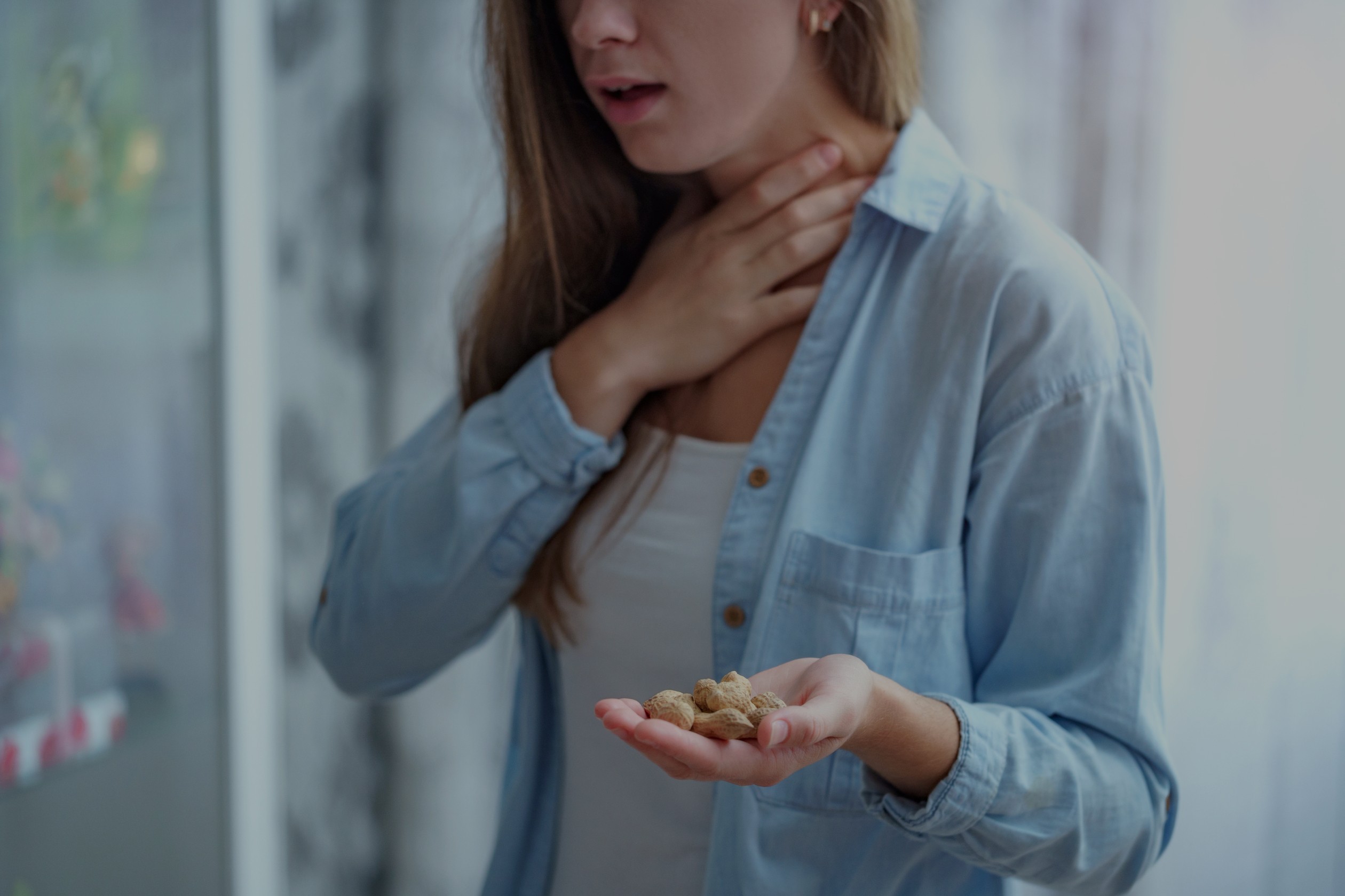 Woman with a peanut allergy holding her neck