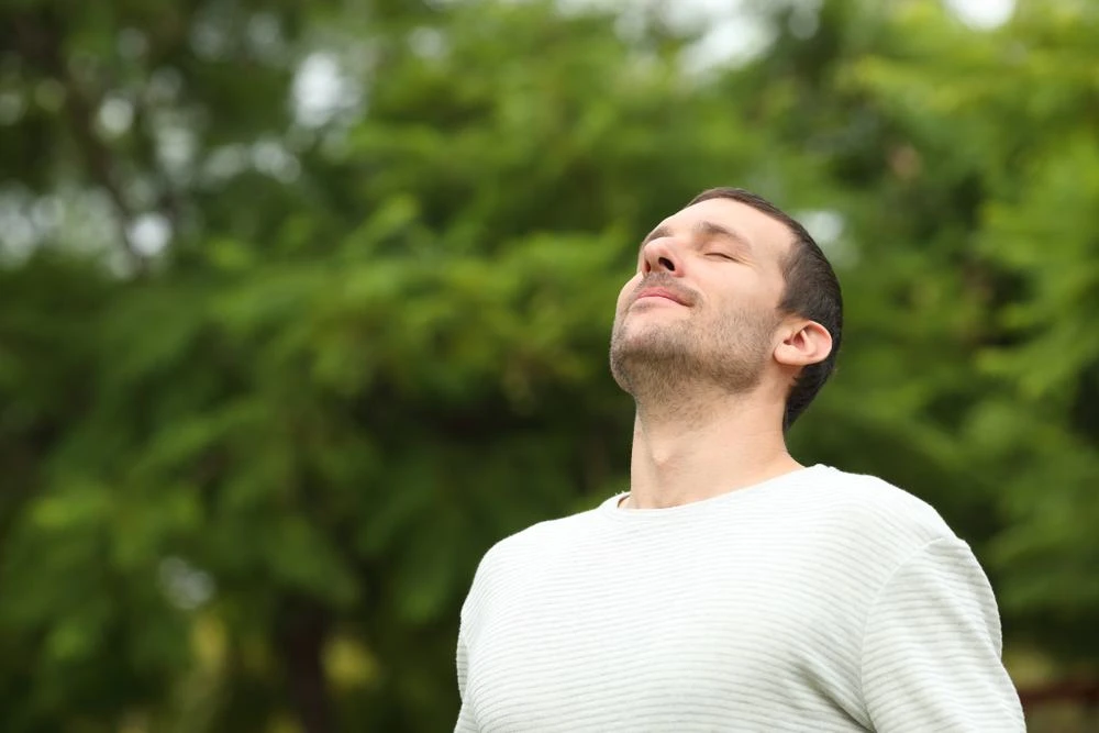 a man breathing fresh air