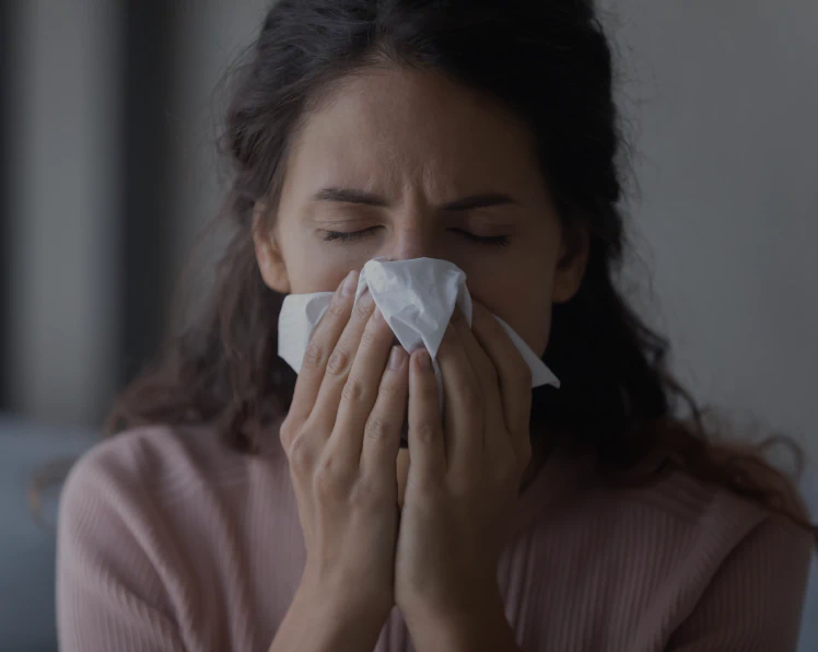 A woman experiencing chronic rhinitis symptoms
