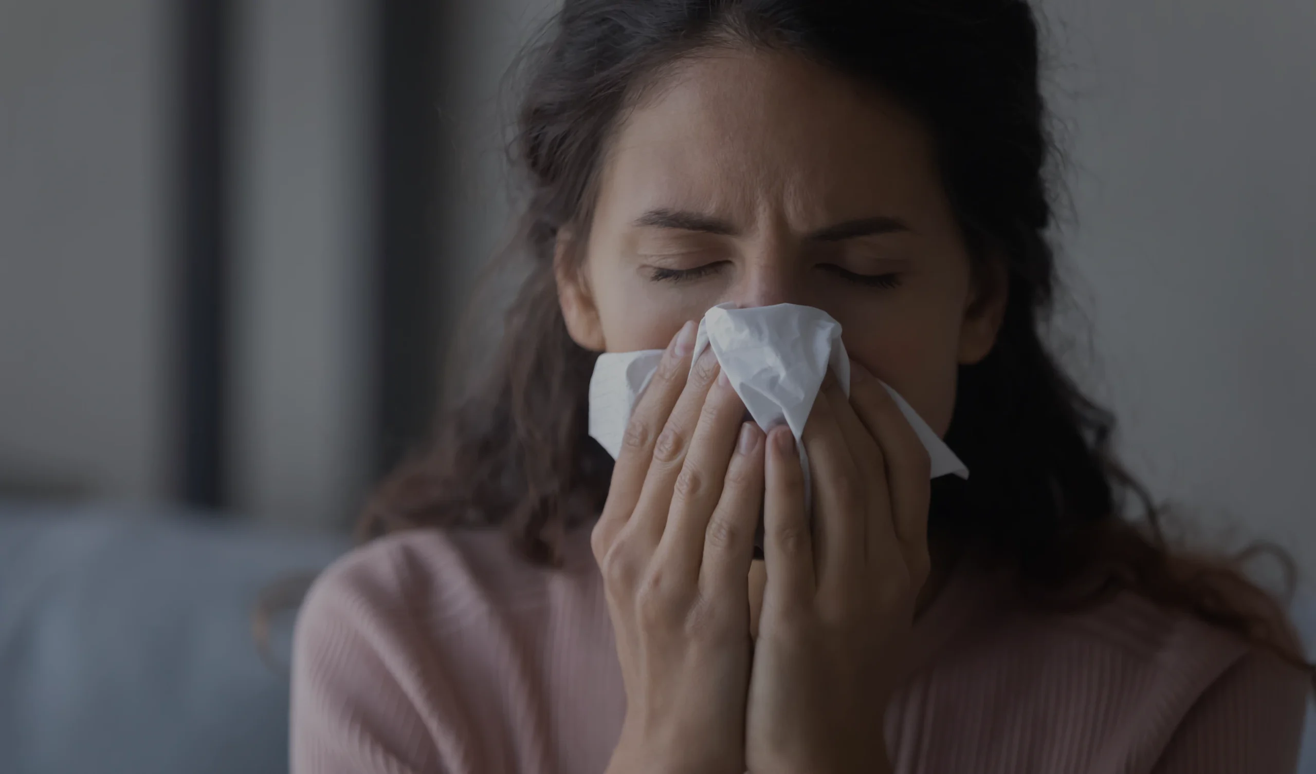 A woman experiencing chronic rhinitis symptoms