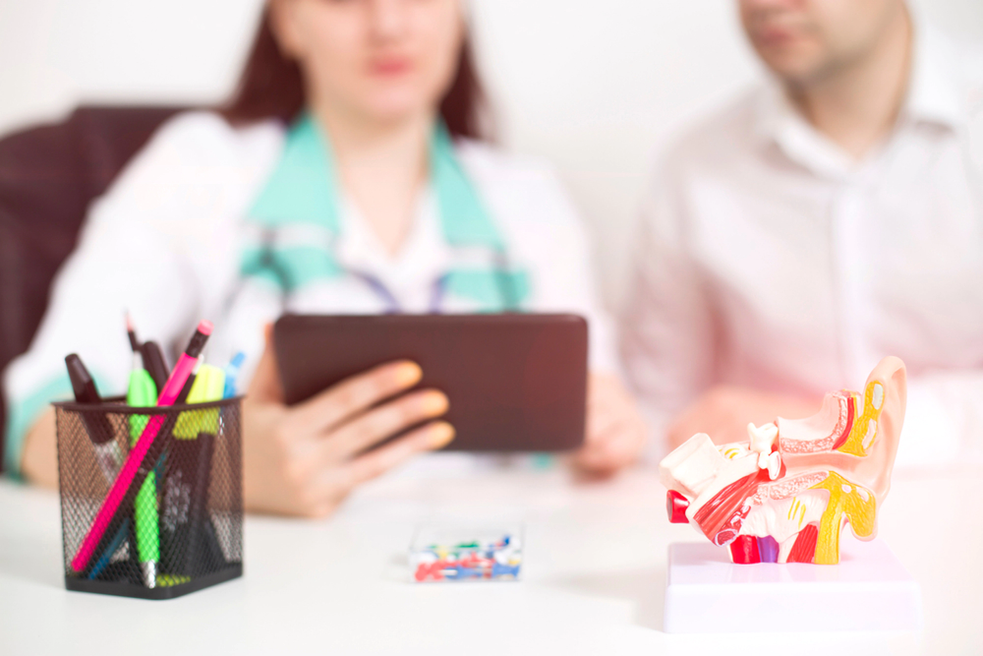 Sinus doctor showing a patient a tablet.