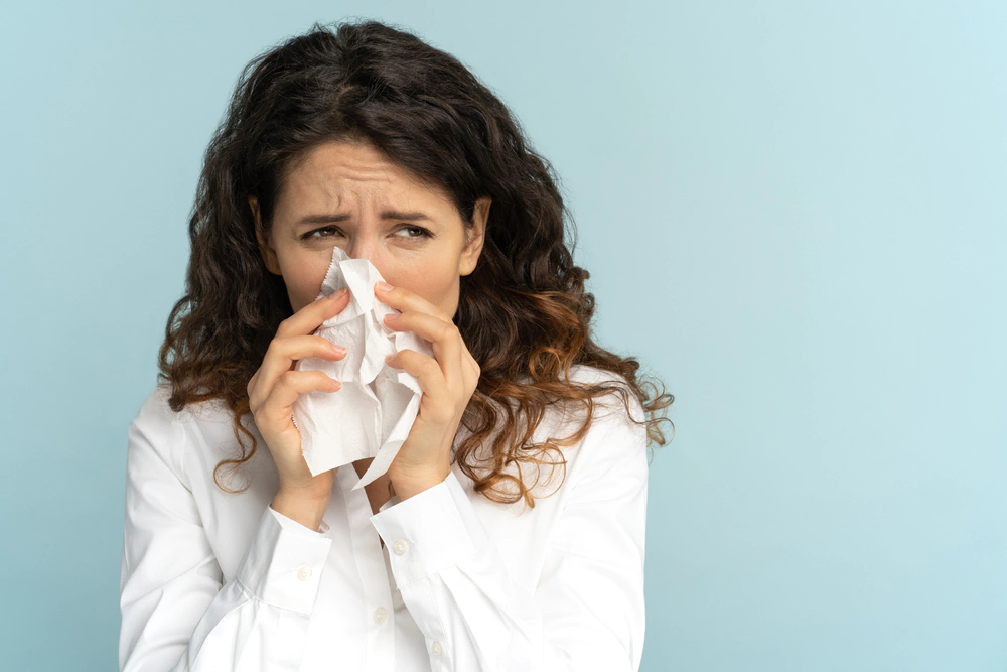 Woman blowing nose