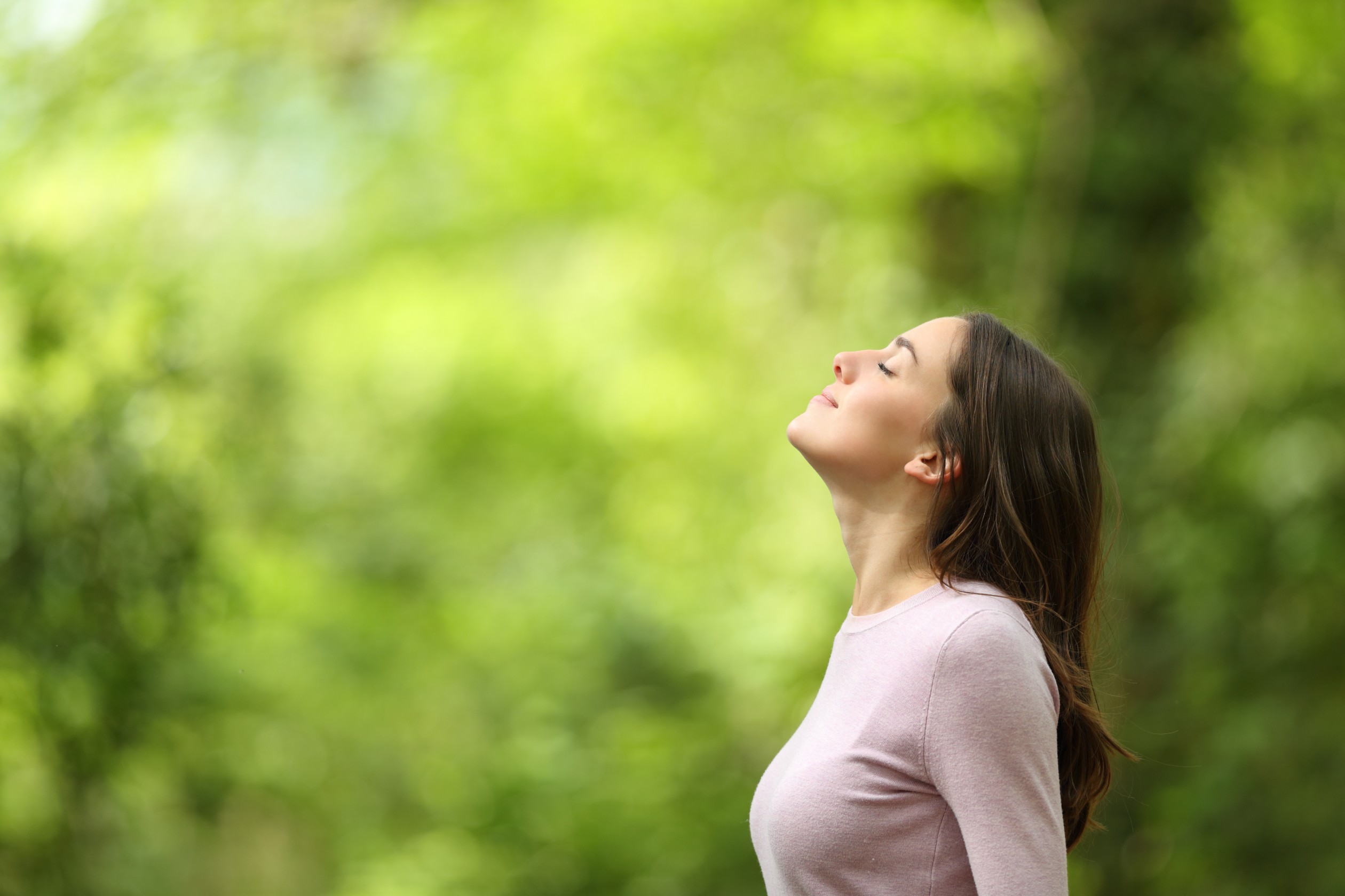 A woman breathing easy after receiving sinus treatment