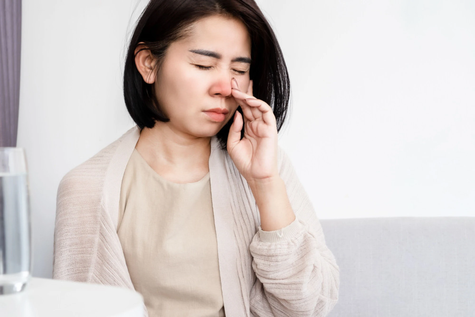 A woman with an inflamed nose due to a nasal obstruction