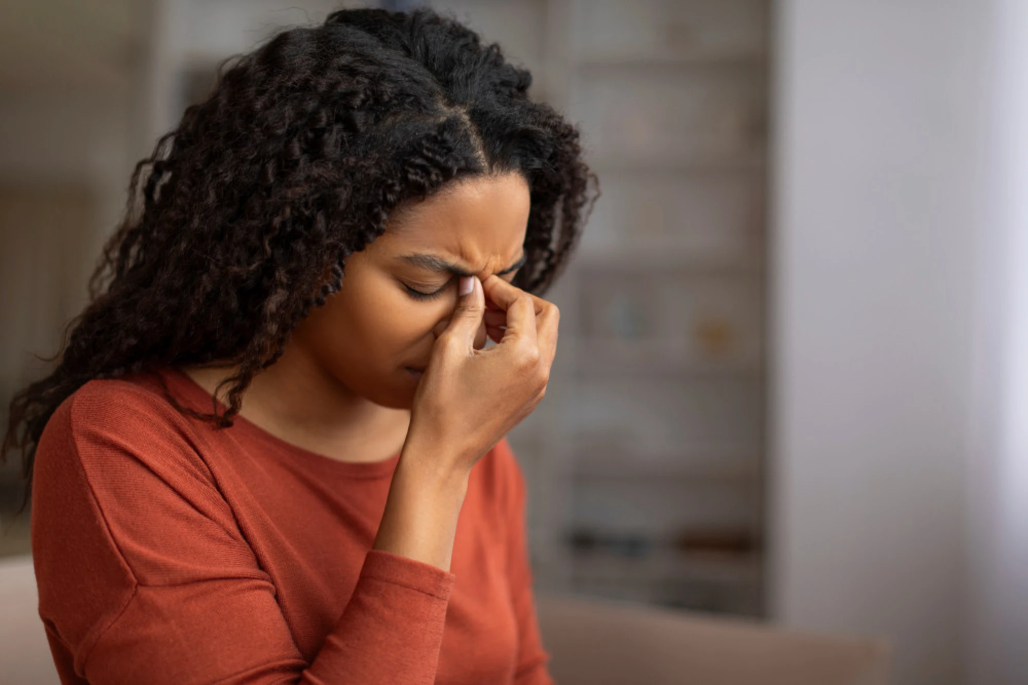 Young black woman experiencing sinus pain