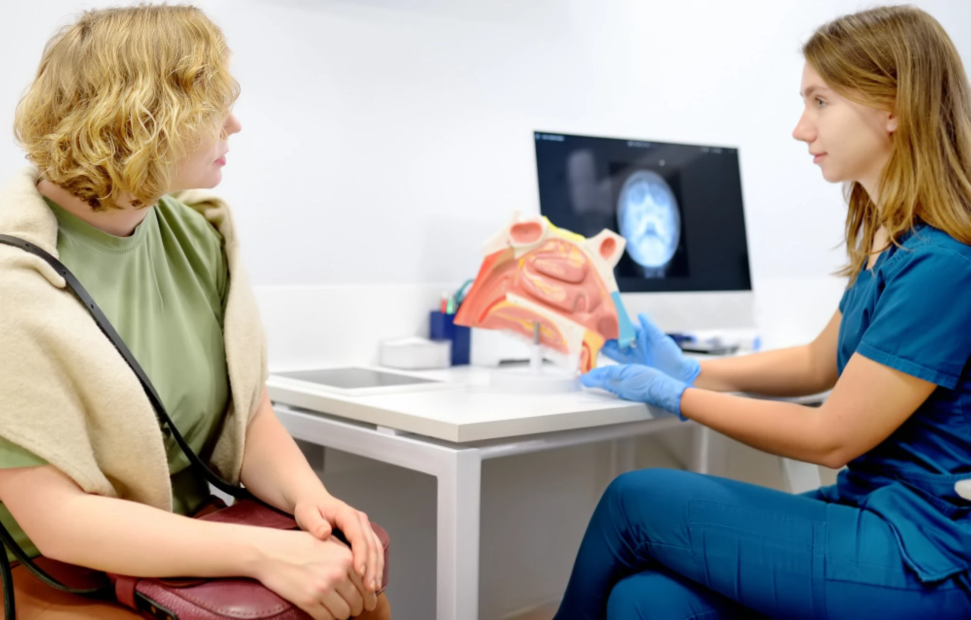 An otolaryngologist consulting with a patient.